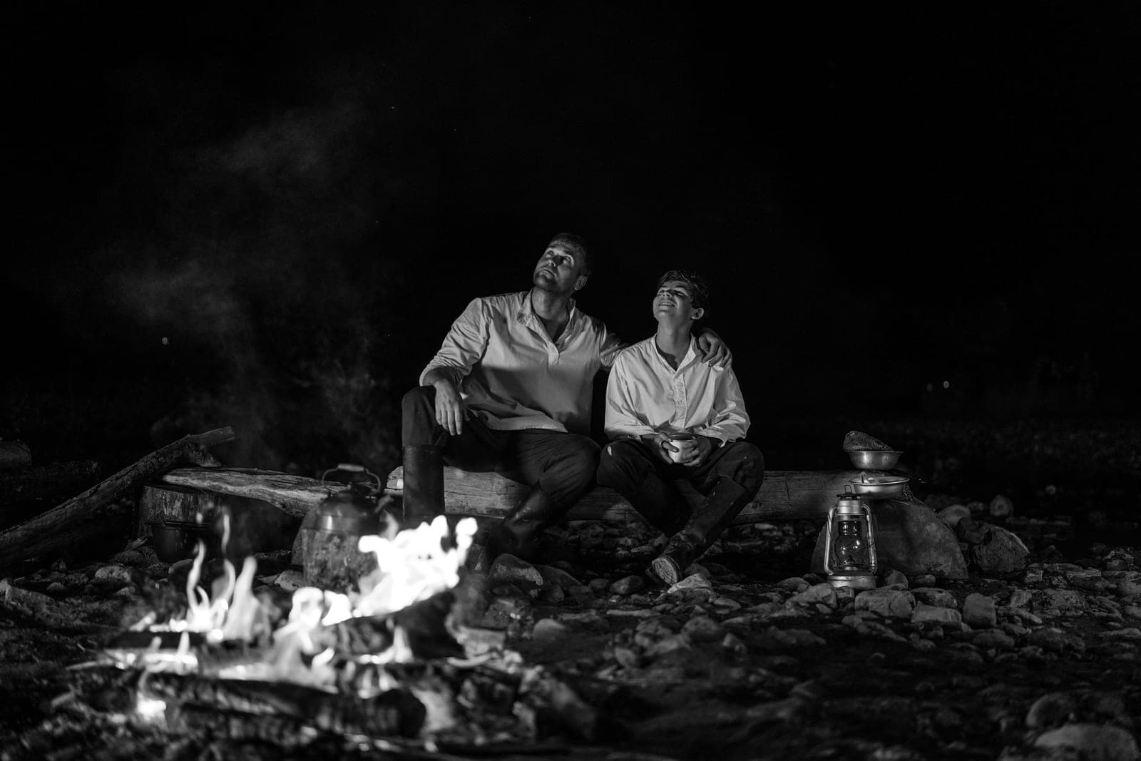 An adult and a child looking up at the night sky together