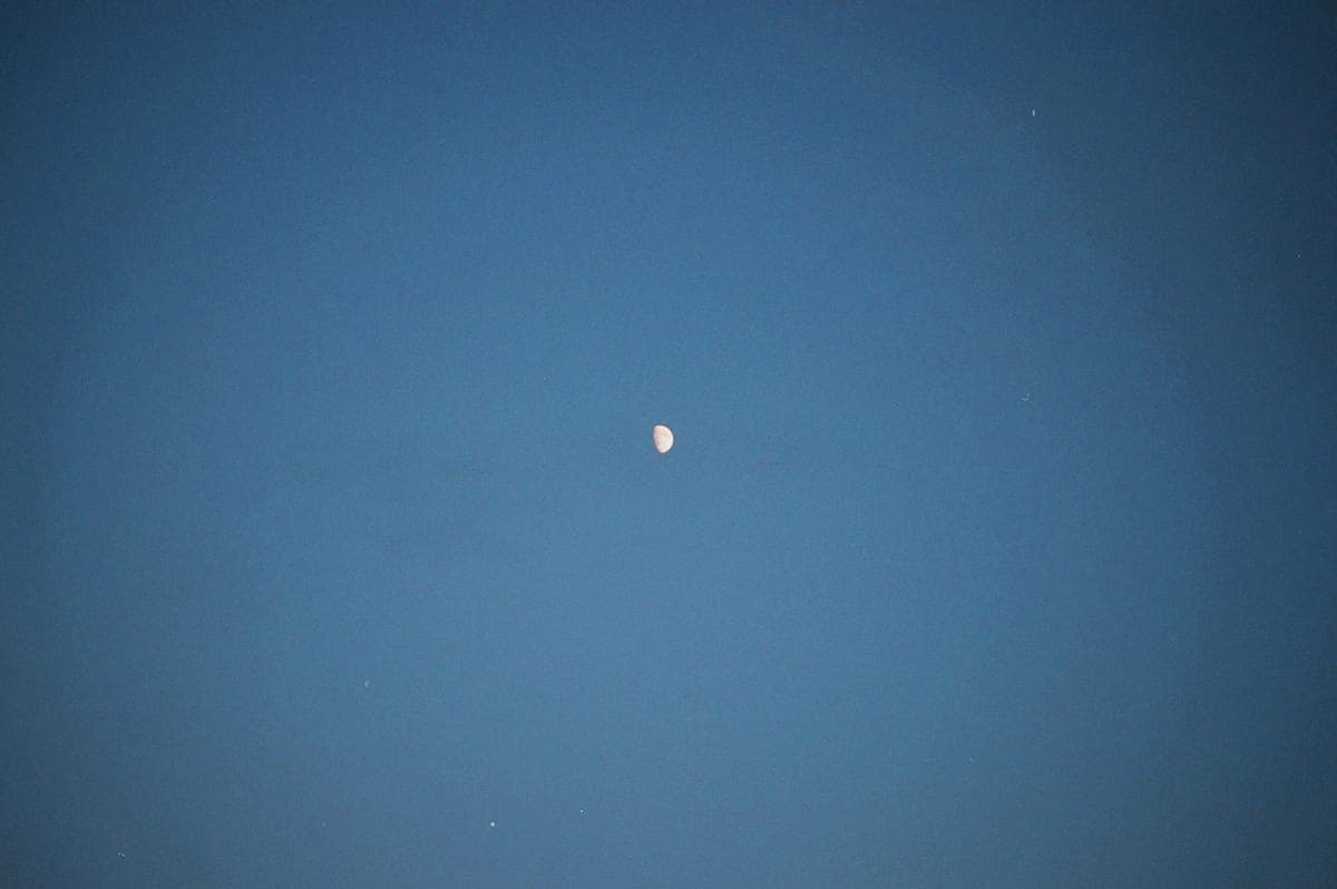 The Moon and a bright planet in a deep blue evening sky